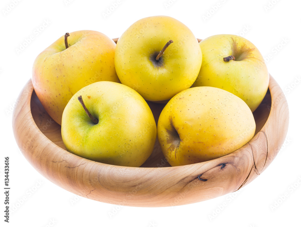 big ripe juicy yellow golden apples in wooden bowl isolated on white background big ripe juicy yellow golden apples in wooden bowl isolated on white background