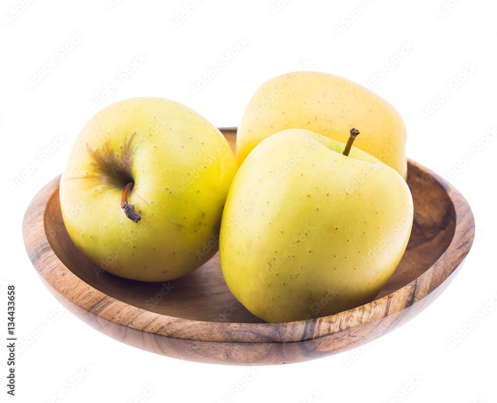 big ripe juicy yellow golden apples in wooden bowl isolated on white background big ripe juicy yellow golden apples in wooden bowl isolated on white background