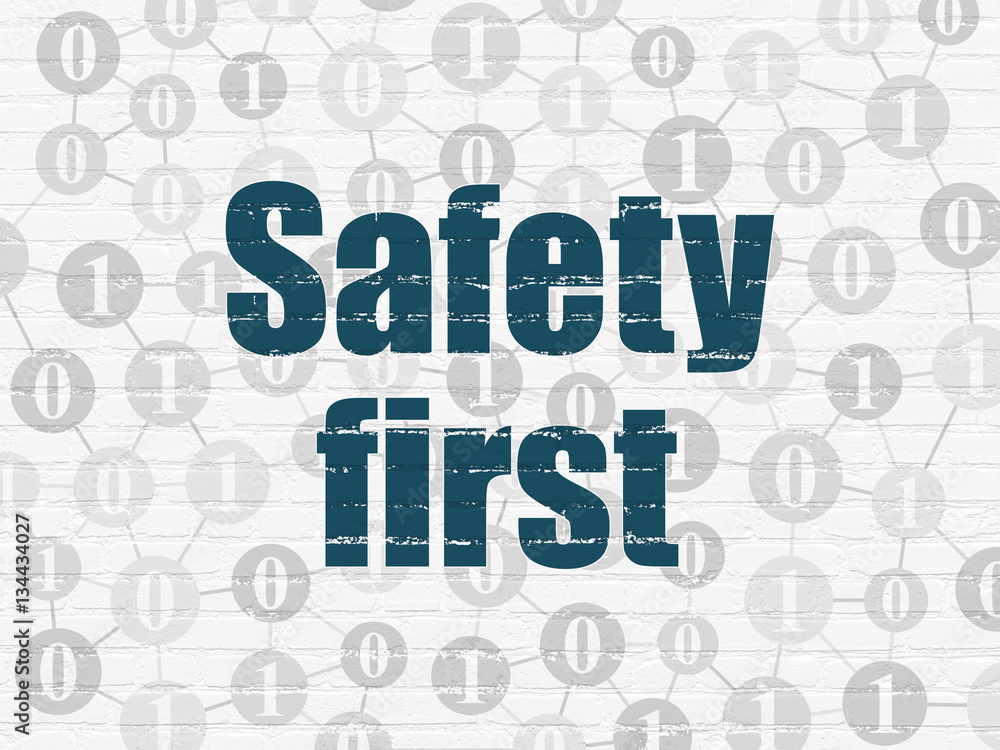 Protection concept: Safety First on wall background Protection concept: Safety First on wall background