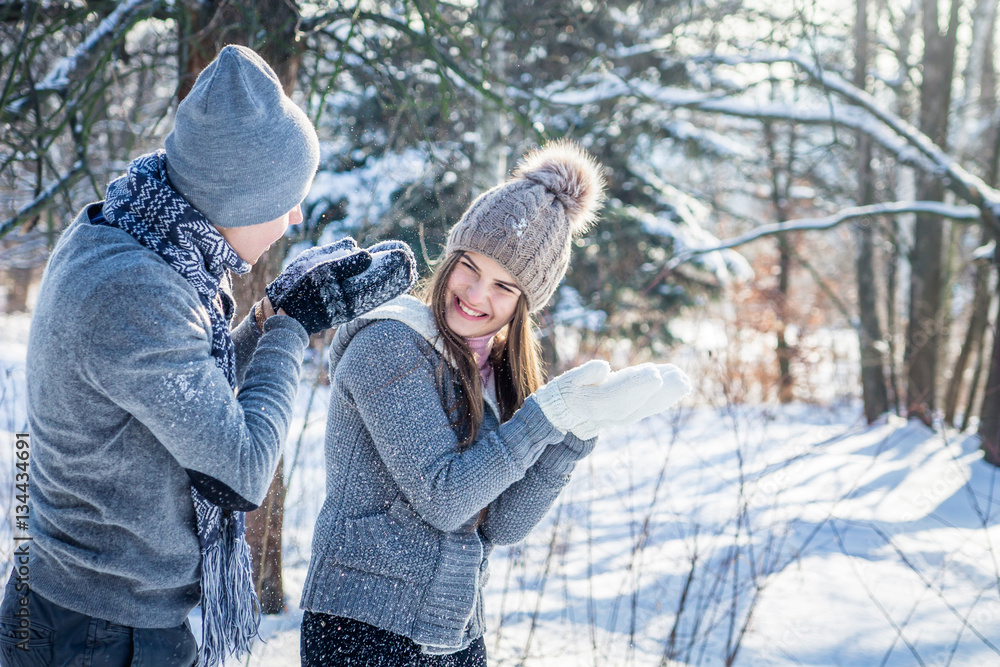 Young couple in love blows snow Young couple in love blows snow