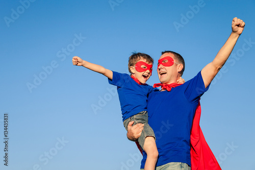 Father and son playing superhero at the day time.