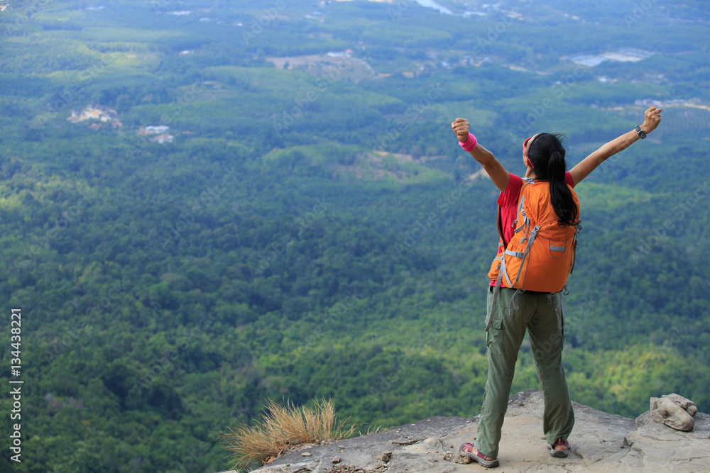 young asian woman hiker enjoy the view on mountain peak