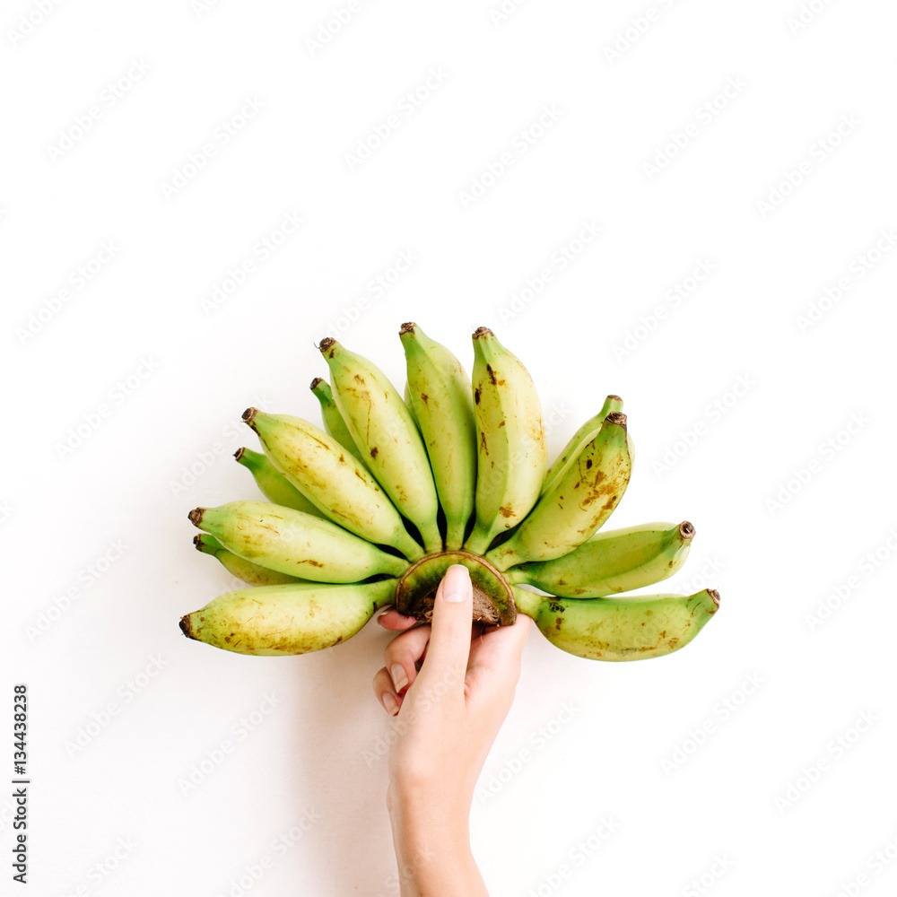 Hand holding bunch of bananas isolated. Flat lay, top view. Creative food concept Hand holding bunch of bananas isolated. Flat lay, top view. Creative food concept