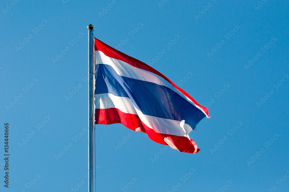 blurred of Thai or siam flag with pole on blue sky background blurred of Thai or siam flag with pole on blue sky background