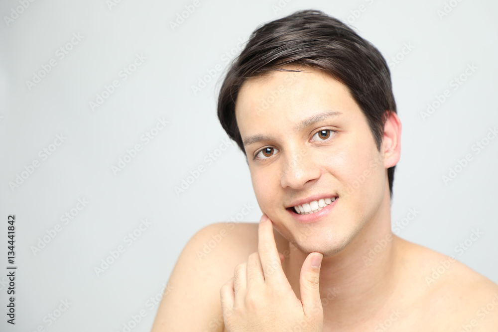young man checking the skin of his face, men's skincare concept, acne treatment young man checking the skin of his face, men's skincare concept, acne treatment