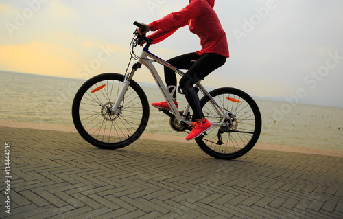 Fototapeta Naklejka Na Ścianę i Meble -  healthy lifestyle young woman riding bike on seaside