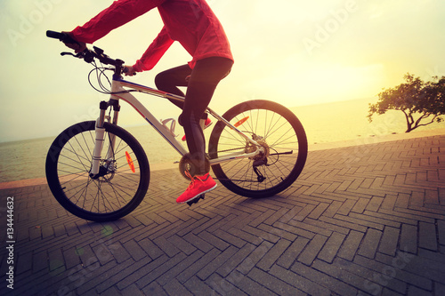 healthy lifestyle young woman riding bike on seaside