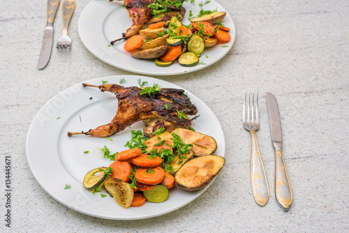Roasted homemade quail with vegetables. Healthy food. Perfect dinner for two