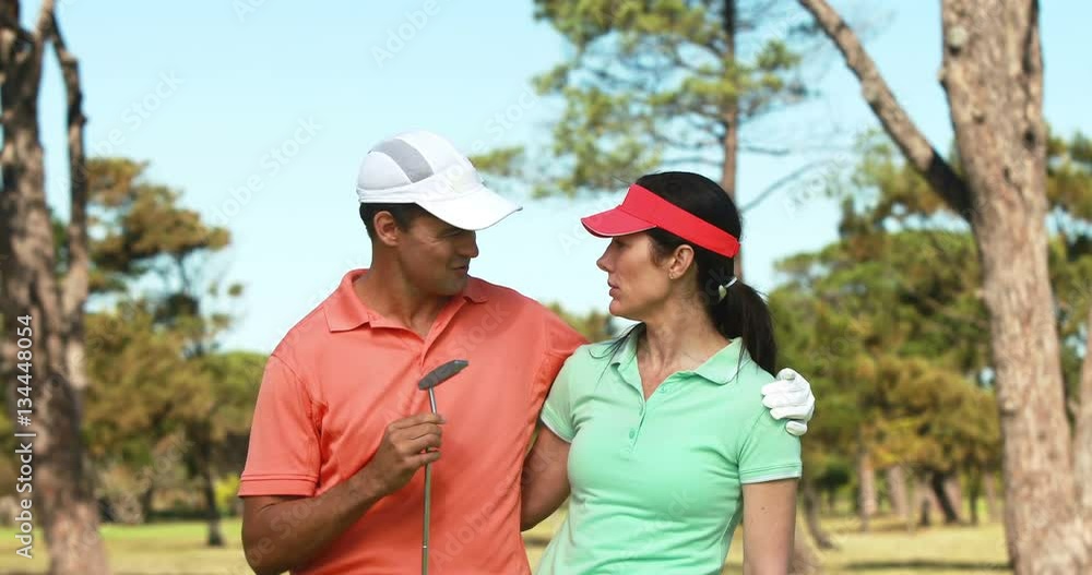 Happy couple interacting with each other while playing golf at golf course 4k Happy couple interacting with each other while playing golf at golf course 4k