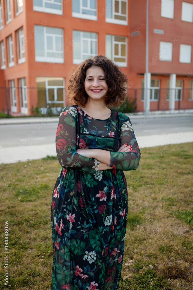Happy curvy girl with curly hair in the street