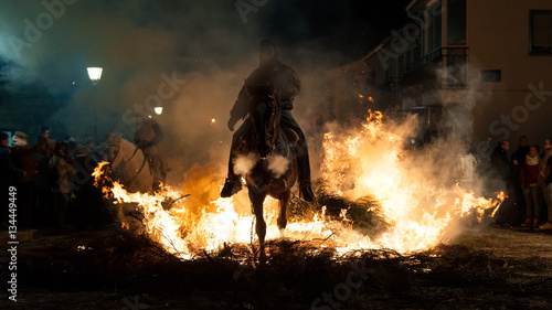 Horses jumping above the fire without fear