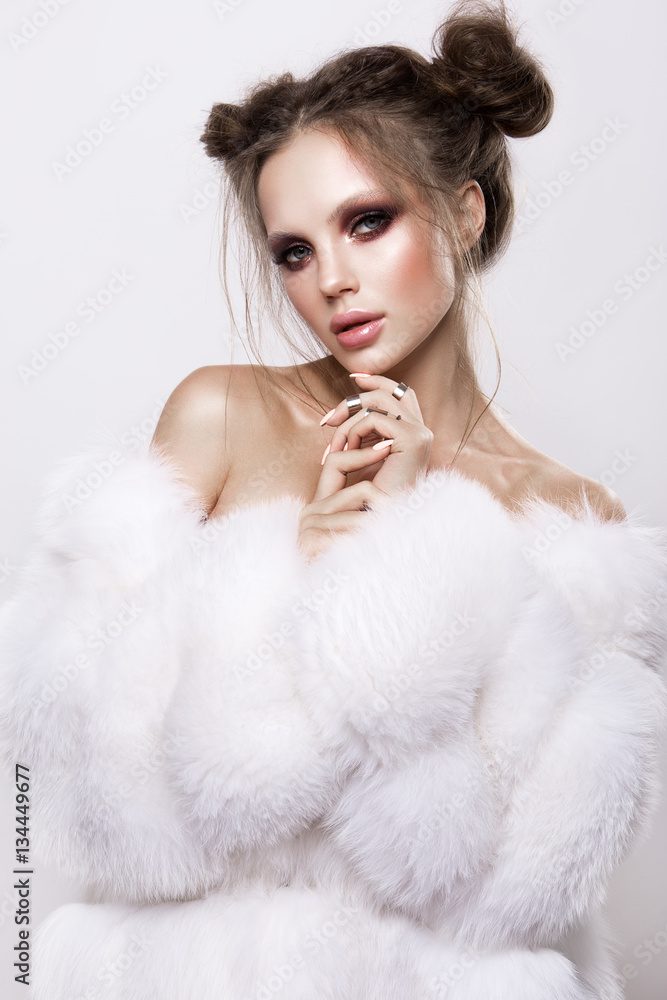 Beautifful european brunet woomen with gloss clean healfy skin, glooss shiny pastel pink lipstik and with trendy fashion hairstyle in white fluffy fur coat Beautifful european brunet woomen with gloss clean healfy skin, glooss shiny pastel pink lipstik and with trendy fashion hairstyle in white fluffy fur coat