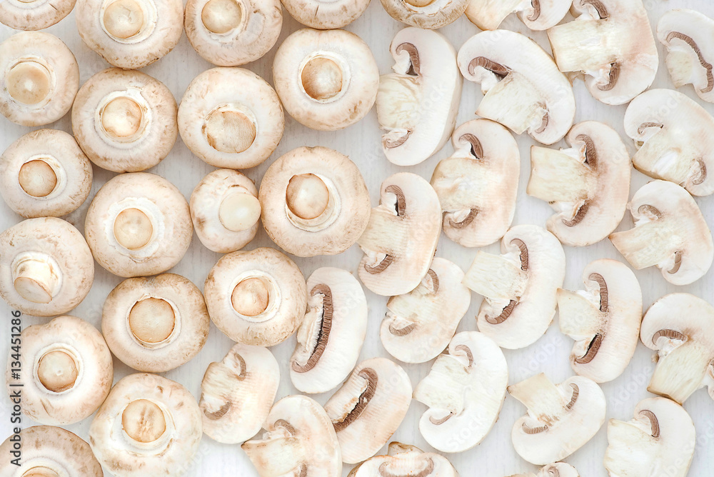Whole and sliced mushrooms on white background