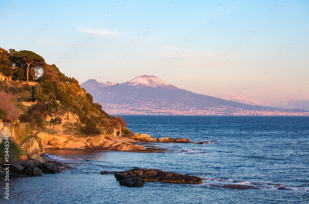 Sunset light on tufaceous slope with Vesuvius mount on the background