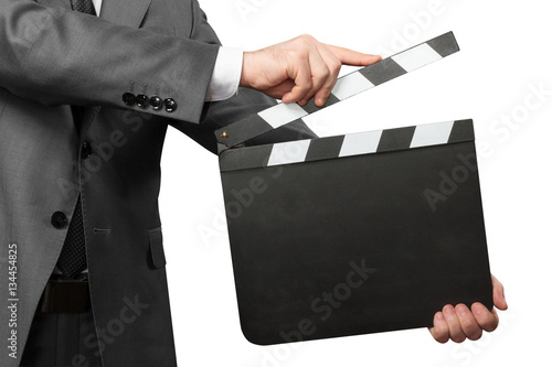 Closeup of man holding movie clapper board on white photo