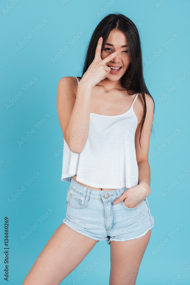 Portrait of a pretty excited woman showing victory sign Portrait of a pretty excited woman showing victory sign