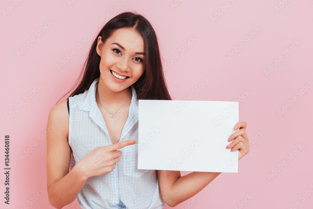 Young attractive woman holding blank billboard with copy space Young attractive woman holding blank billboard with copy space