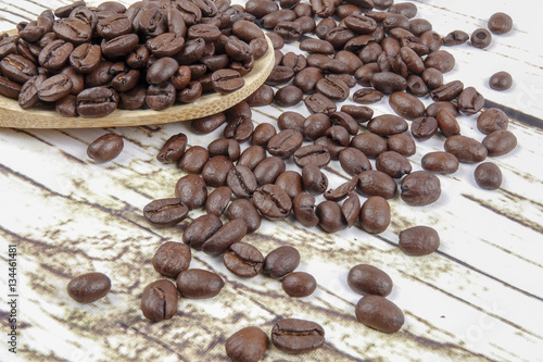 coffee beans and wooden spoon on old rusty background