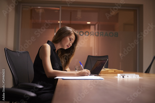 Young Asian businesswoman working alone late in an office