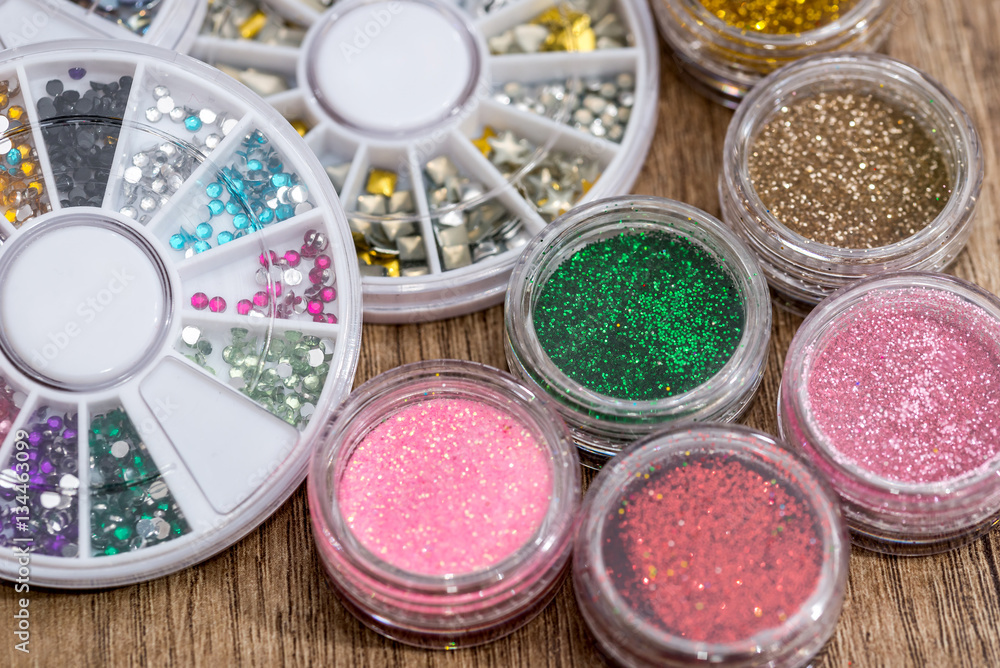 many round jars with multi-colored bright glitter for nail polish. many round jars with multi-colored bright glitter for nail polish.