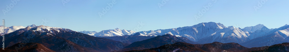 panoramic photo of the mountain peaks a Sunny winter day