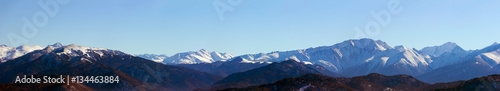 panoramic photo of the mountain peaks a Sunny winter day