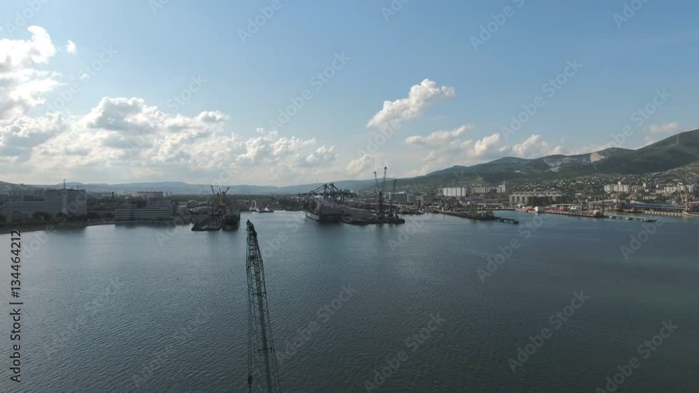 Industrial seaport, top view. Port cranes and cargo ships and barges. Loading and shipment of cargo at the port. View of the sea cargo port with a bird's eye view. Industrial seaport, top view. Port cranes and cargo ships and barges. Loading and shipment of cargo at the port. View of the sea cargo port with a bird's eye view.