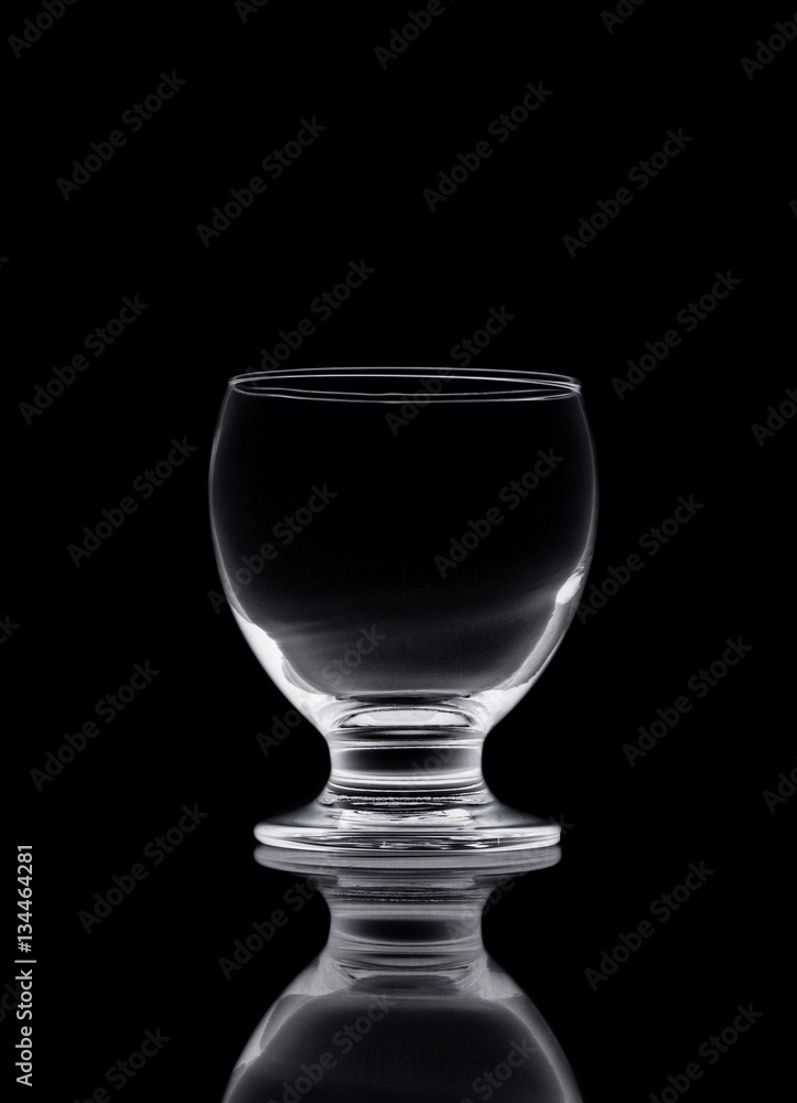 Shot of empty crystal glass on black isolated. Shot of empty crystal glass on black isolated.
