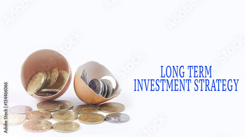 Egg shell and coins with investment and business text conceptual. photo