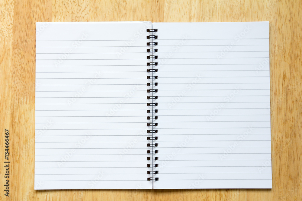 Blank paper note book on wood table background Blank paper note book on wood table background