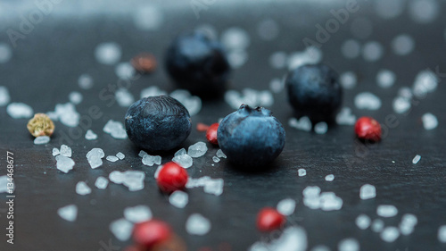 Blueberry berries with sugar granules close-up on a dark background