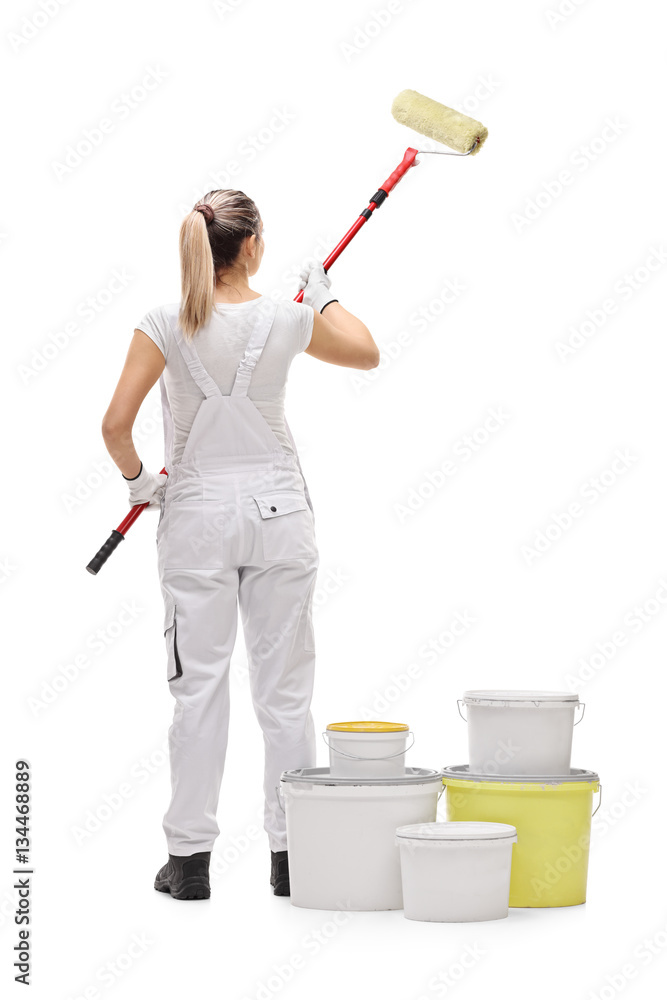 Female painter painting with a paint roller Female painter painting with a paint roller