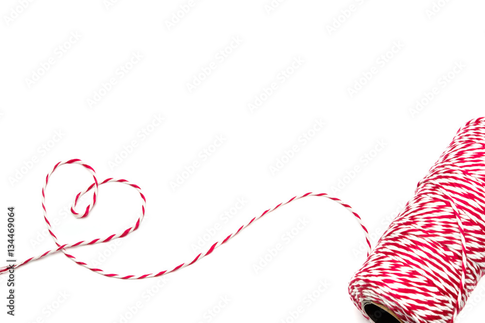 Heart made from baker's twine rope red and white on white backgr Stock