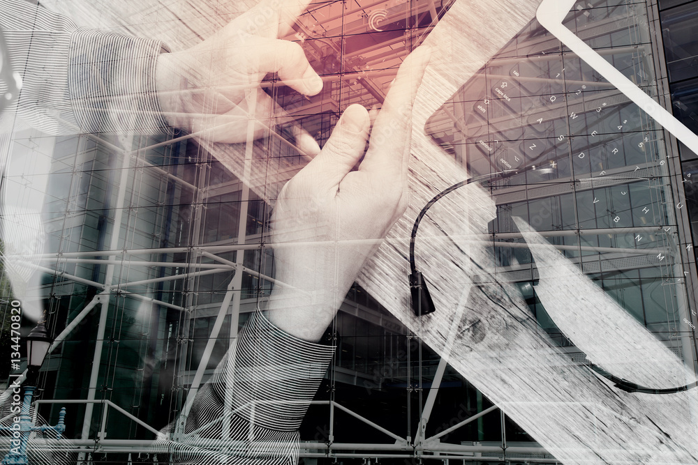 double exposure of man hand using VOIP headset with digital tabl