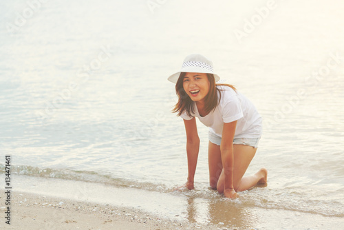 Young woman playing water on the beach © PK4289