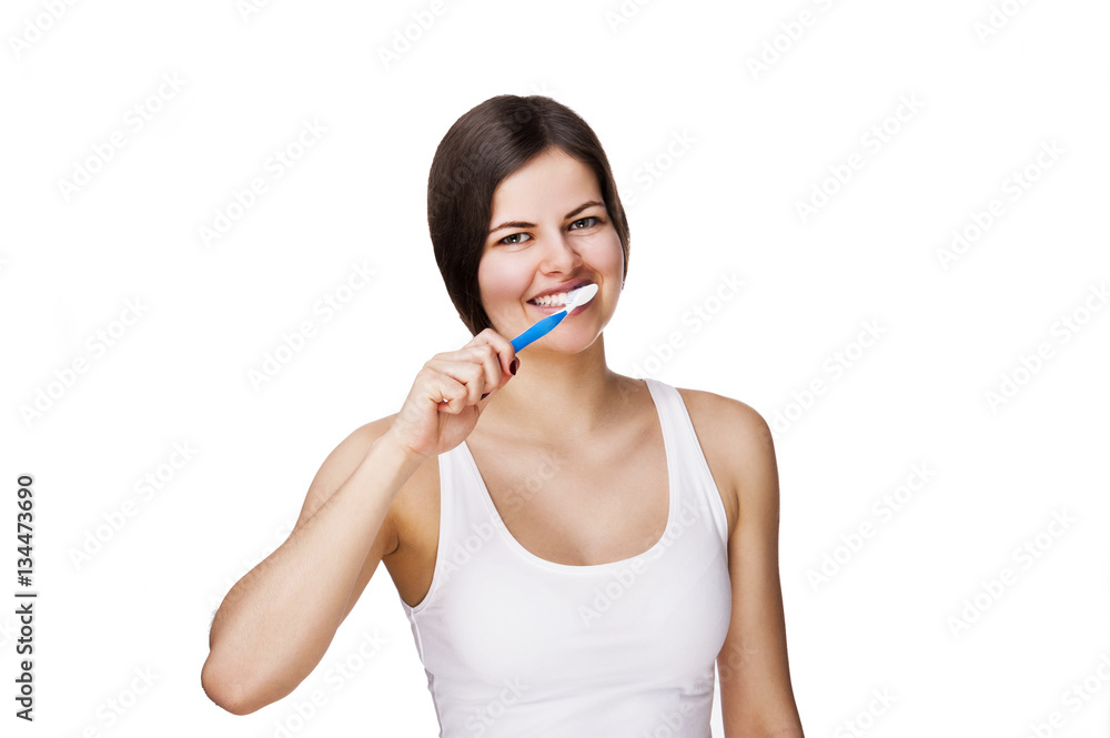 Smiling young woman with healthy teeth holding a tooth brush Smiling young woman with healthy teeth holding a tooth brush