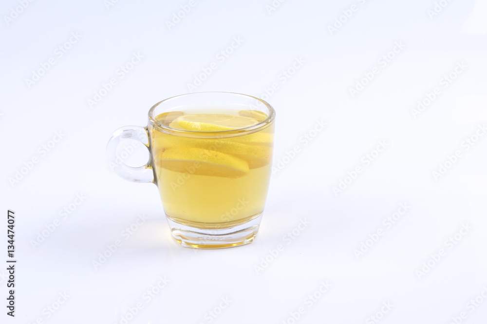 Hot lemon tea in the glass on white background. Hot lemon tea in the glass on white background.