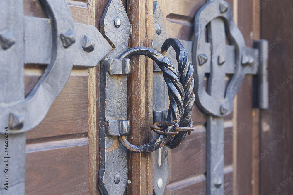 Steel handles on ancient wooden gate of church