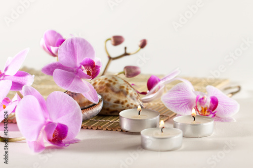 Spa still life with aromatic candles, orchid flower sea shells
