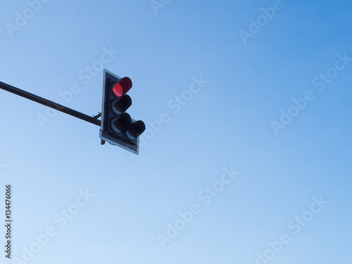 Traffic light red with blue sky background