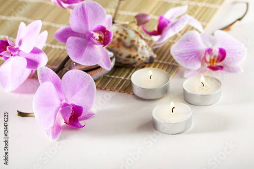 Spa still life with aromatic candles, orchid flower sea shells