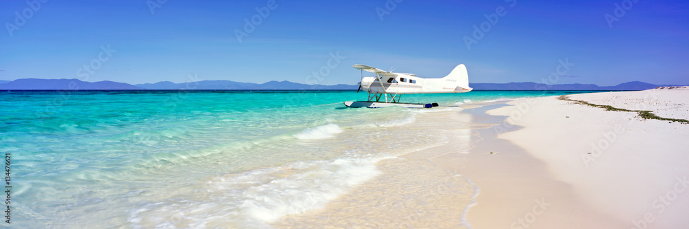 A seaplane on a sand island on the Great Barrier Reef in Australia