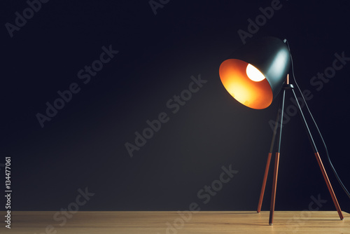 Desk lamp on empty wooden office table photo