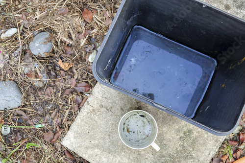 Wallpaper Mural Stagnan water in rubbish container and plastic cup potentially for musquitoes breeding ground. Blurred image. Torontodigital.ca