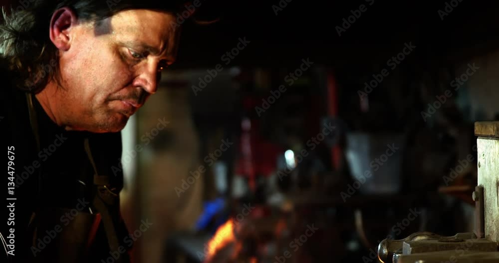 Blacksmith holding hammer in workshop 4k Blacksmith holding hammer in workshop 4k
