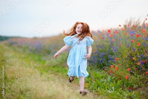 a little girl running near the field. The joy on the face 
