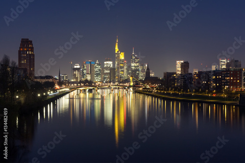 Picturesque view of business district with skyscrapers and mirror reflections in the river at dark night, Frankfurt am Main, Germany © Kavalenkava