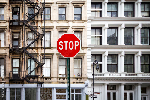Stop Sign in front of Old Historic Buildings in New York City NYC
