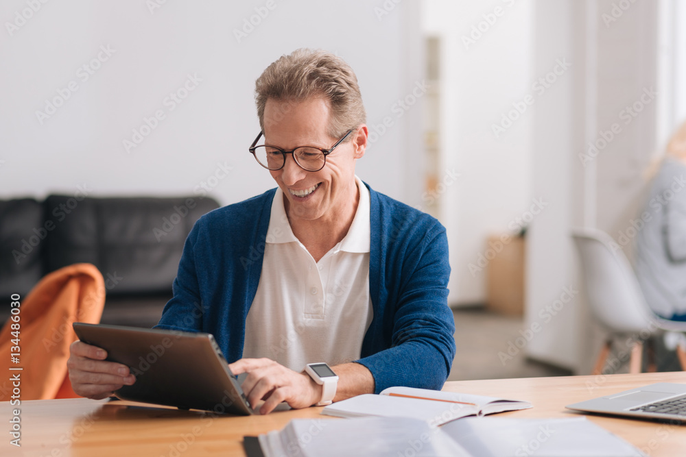 Delighted nice man using the tablet Delighted nice man using the tablet