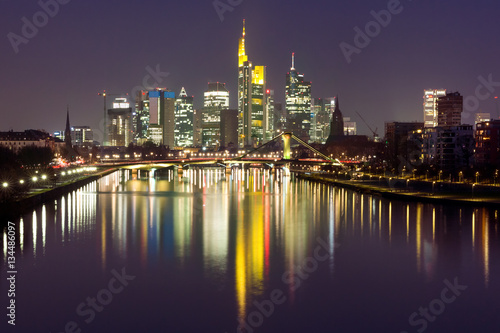Picturesque view of business district with skyscrapers and mirror reflections in the river at dark night  Frankfurt am Main  Germany
